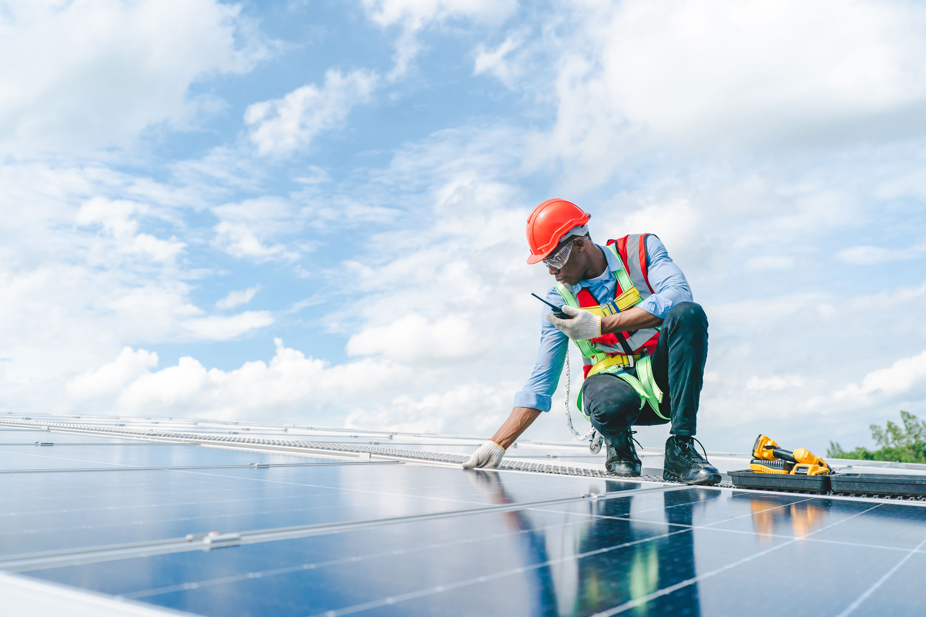 Solar installer inspecting rooftop panels