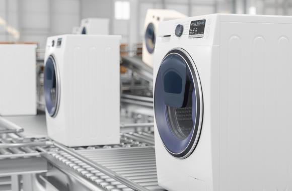 Washing machines on conveyer belts in a factory