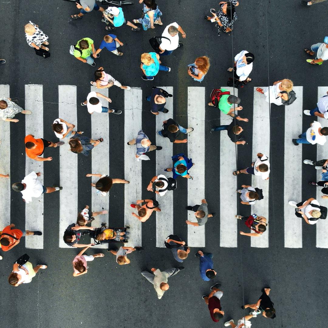 Many people in a crosswalk viewed from above