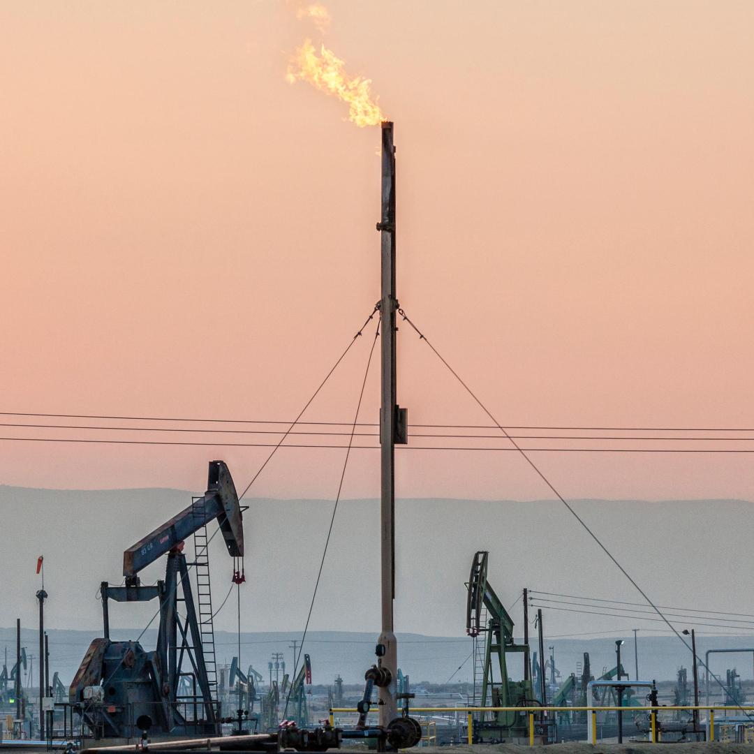 Oil wells and flame coming from flare stack