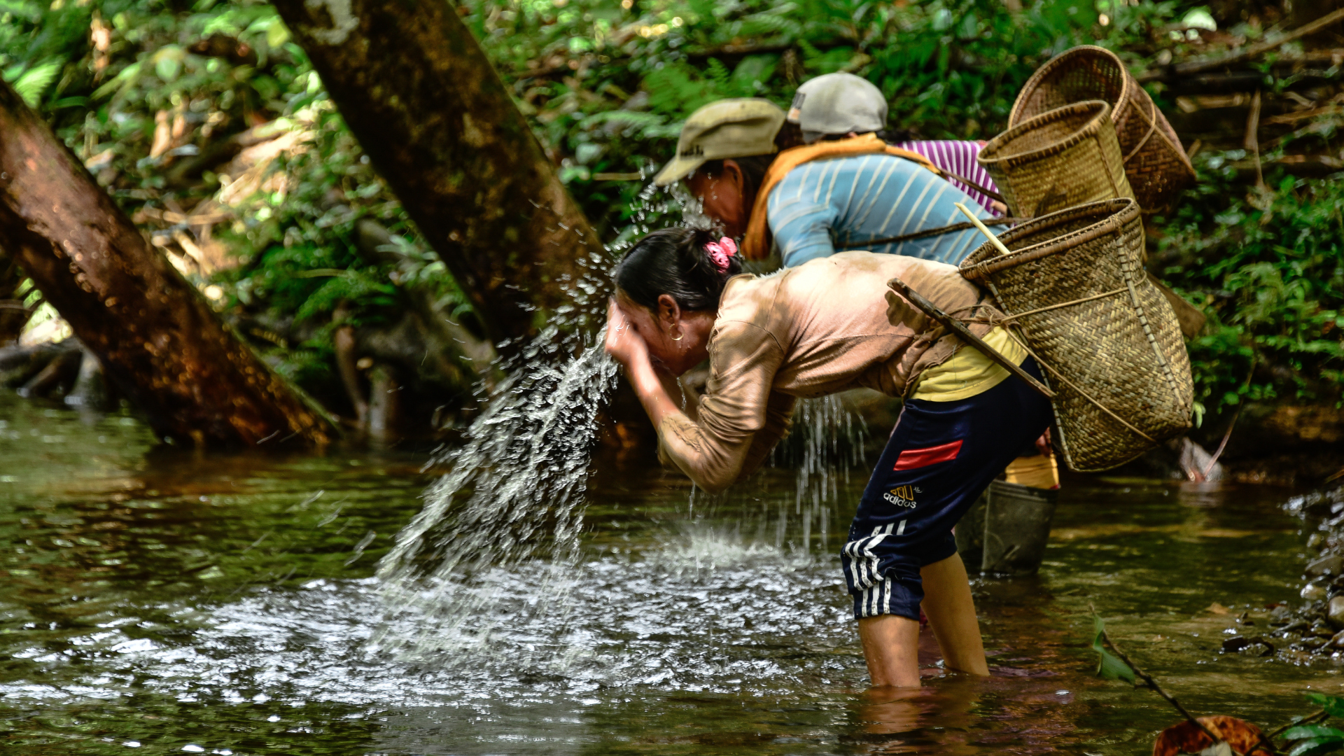 Women harvesters refreshing in river